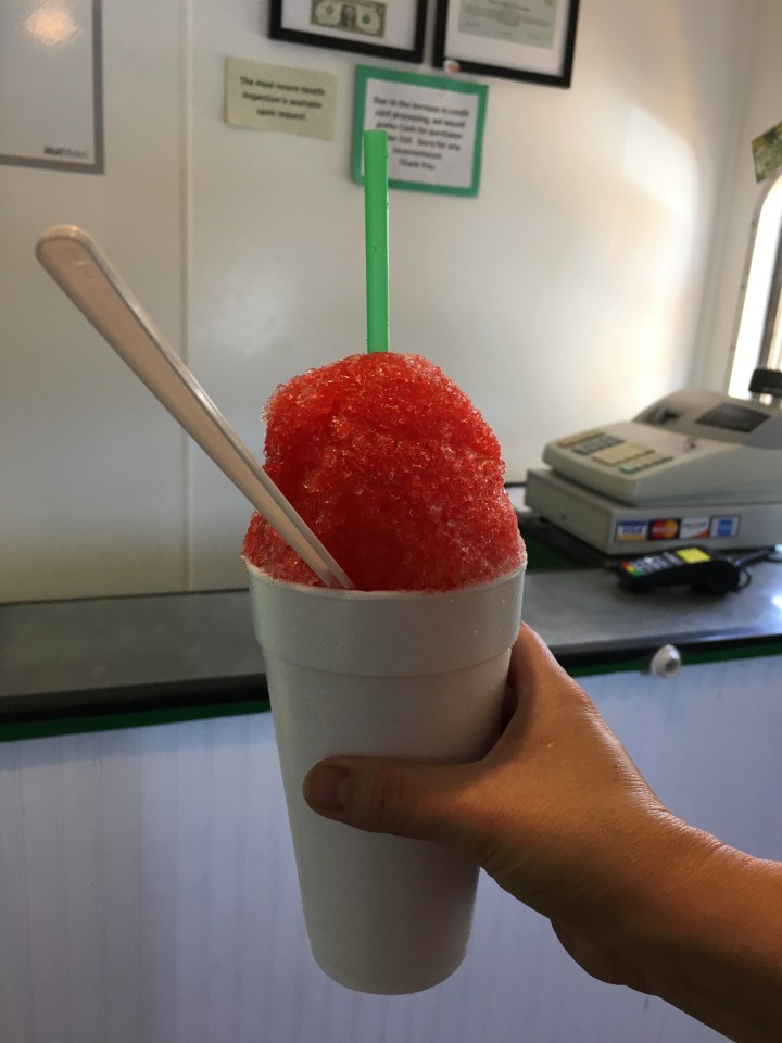 Cherry shaved ice belonging to a lady that didn't want her picture taken.