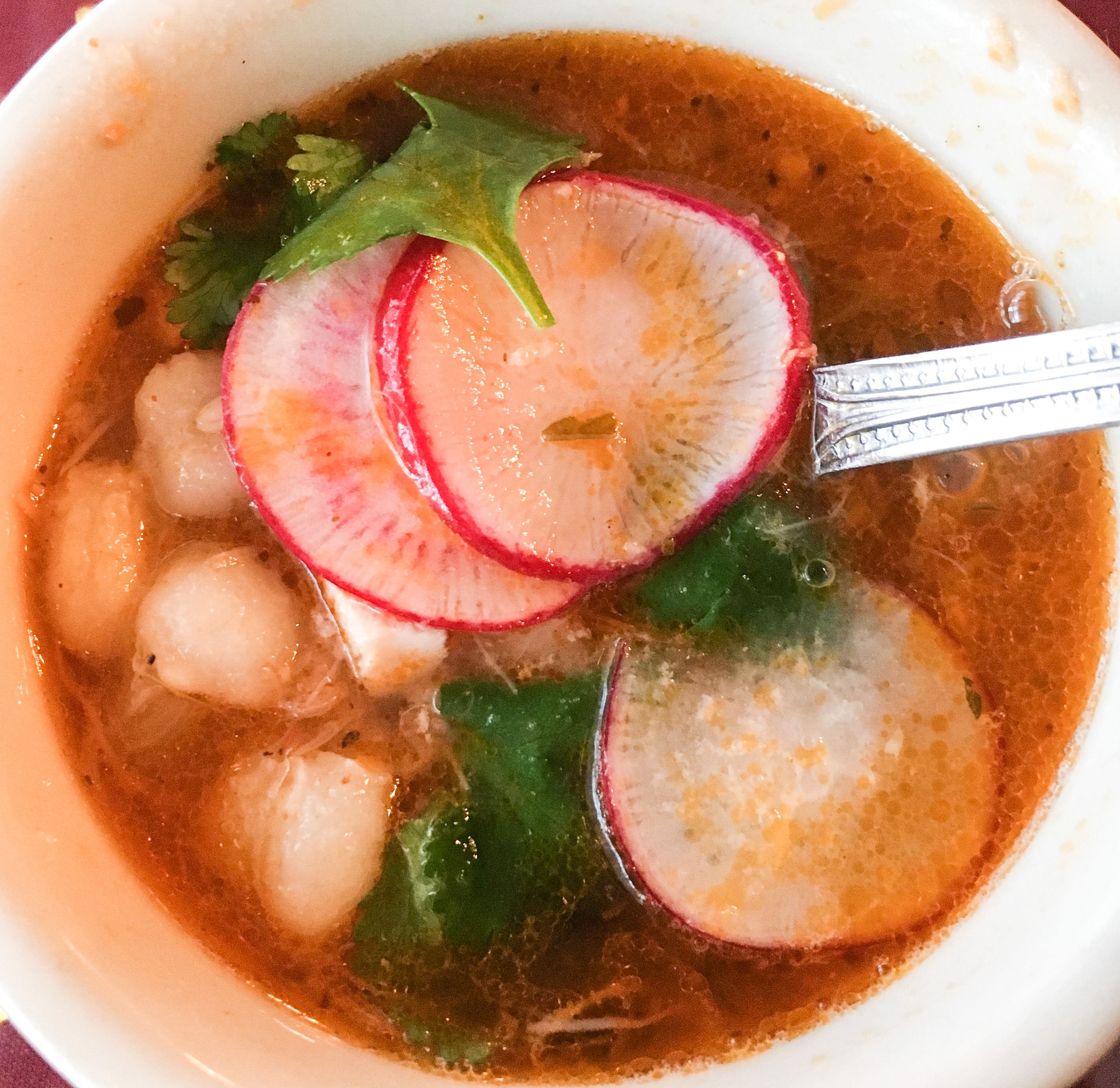 A cup of savory posole soup.