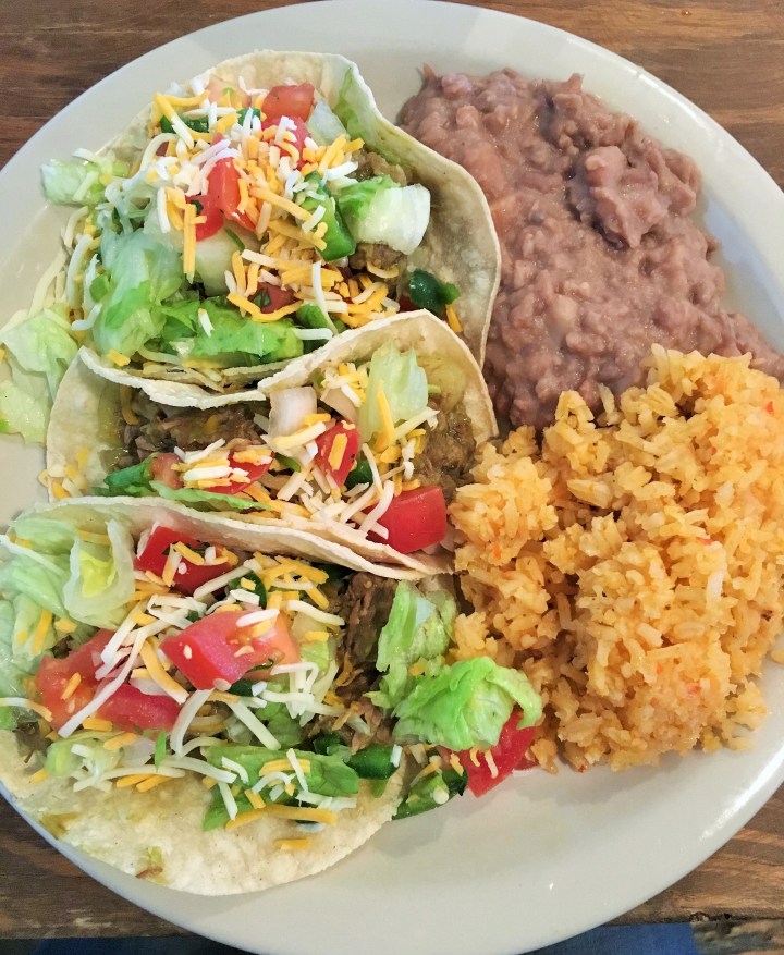 Chile Verde taco plate with beans and rice.
