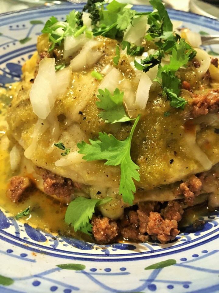 A stack of green with beef, homemade green sauce with chiles from Marfa's Mac White.