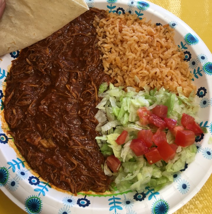 Chicken mole plate served with four warm corn tortillas. Deliciousness.